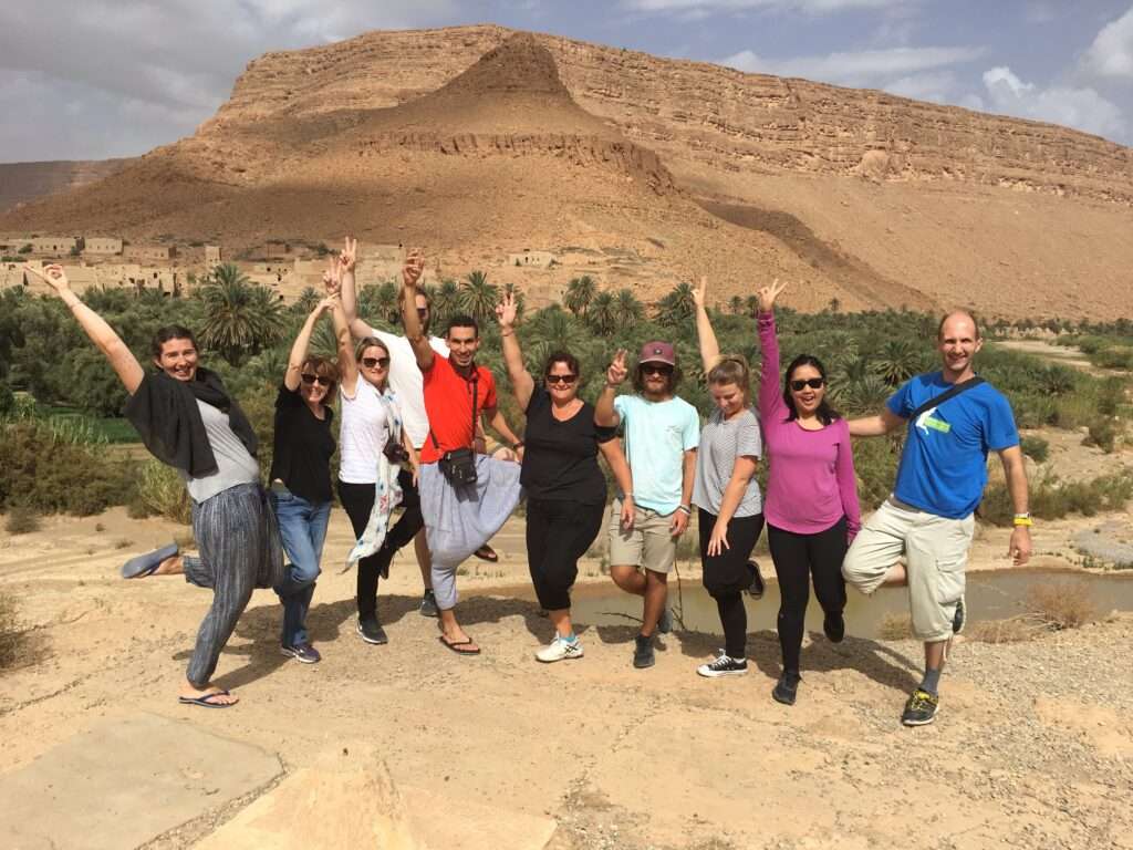 Tour leader Ilyas Baayay with a group of travelers exploring Morocco – Uncovered Trails