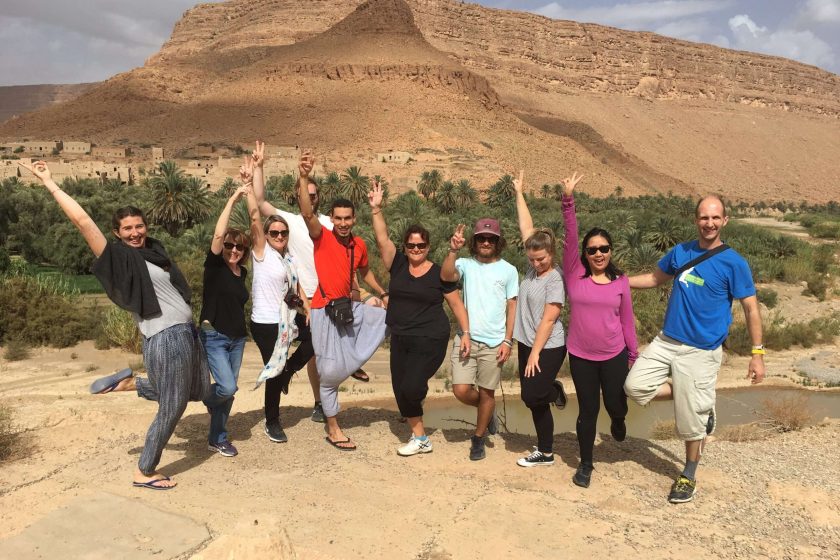 Tour leader Ilyas Baayay with a group of travelers exploring Morocco – Uncovered Trails